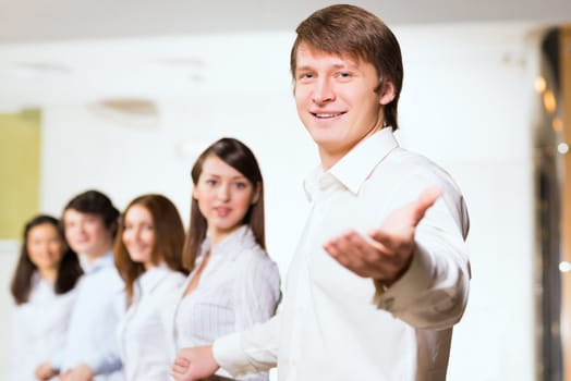 group of people holding hands, man holds out his hand, the concept of teamwork