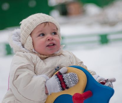 Little girl sits on the swing