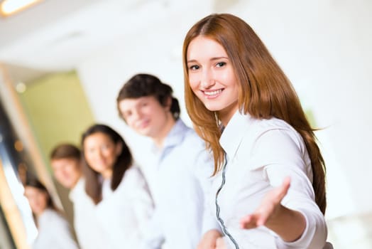 group of people holding hands, woman holds out her hand, the concept of teamwork