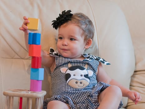 Little girl plays with cubes