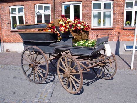 Horse carriage decorated with many colorful flowers