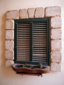 Country style window handmade stone frame and wooden shutters