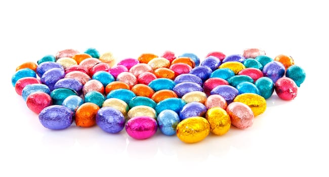 Colorful chocolate easter eggs over white background