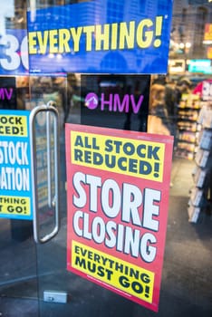 LONDON, UK - MARCH 16: HMV store front window in Piccadilly Circus with closure promotion posters. The famous chain opened its first store in 1921 and went into administration in January 2013. March 16, 2013 in London.
