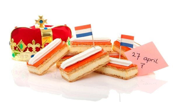 Typical Dutch tompouce sweet with crown over white background