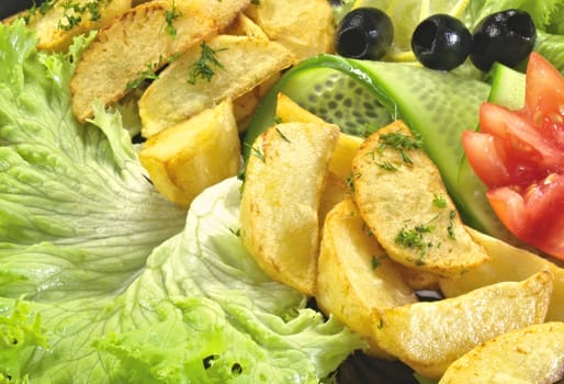 Fried fish with new potatoes, tomatoes, lettuce