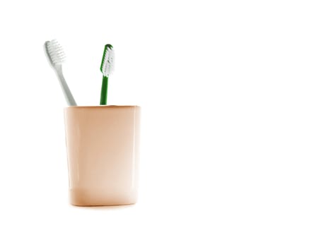 Two toothbrushes in glass