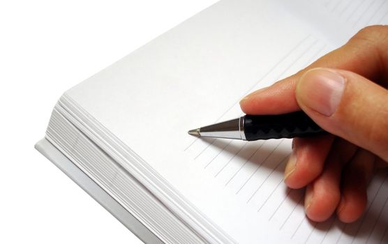 pen in hand writing on the notebook