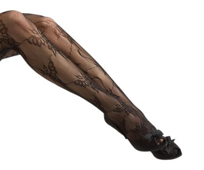 Close-up of young woman's legs in high-heeled black shoes isolated on white