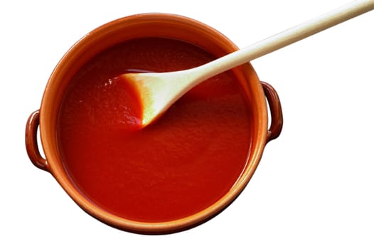 Terracotta pot and wooden spoon with tomato sauce with clipping path