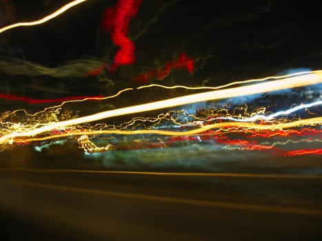 Abstract light trails captured from cars, signs, and other landmarks.