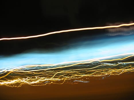 Abstract light trails captured from cars, signs, and other landmarks.