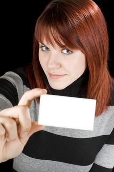 Smiling redhead girl holding a blank business or greeting card.

Studio shot.