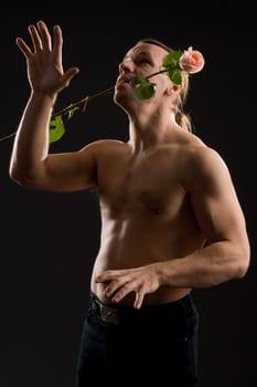 clambering romantic man with pink rose
