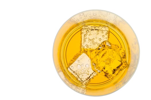 Glass of yellow drink with ice from top with clipping path