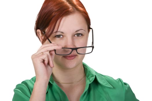 Portrait of a redheaded girl putting on her glasses.