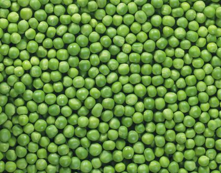 Shelled fresh ripe green peas background