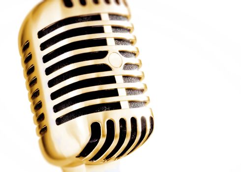golden vintage microphone isolated on white background
