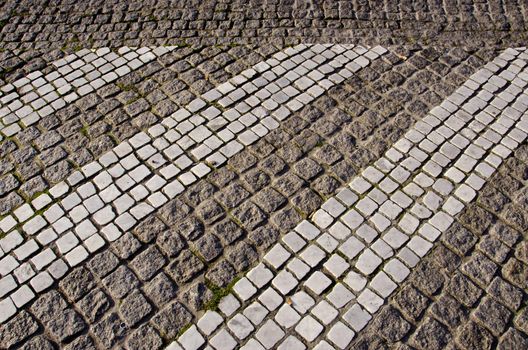 Path paved with small stones. Architectural background of floor.