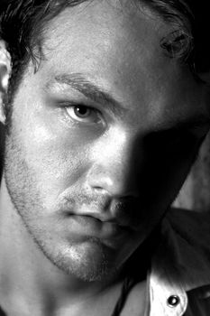 A black and white close up of a young man