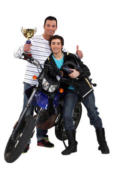 Father and son with a motorbike trophy