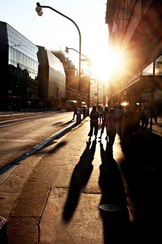 People walking on the street of Prague at sunset