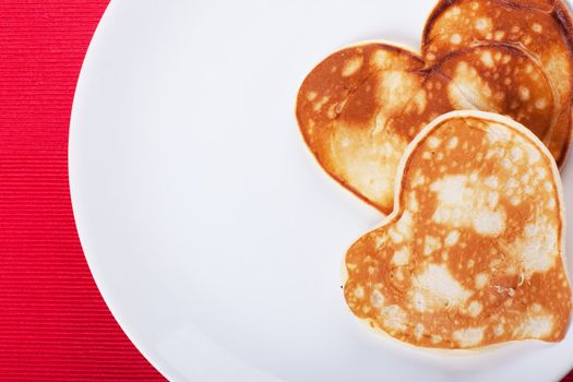 Two heart-shaped pancakes on a plate