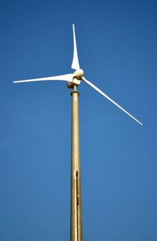 Wind turbine for sustainable energy production. Single windmill and blue sky
