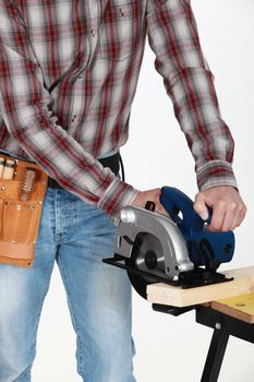 Craftsman with chainsaw cutting wood