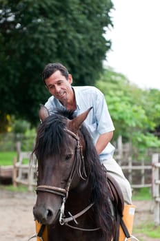 Horses and riders on a farm in Ecuador