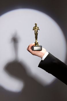 The winner holds in his hand the award. Fake Oscar prize