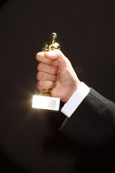 The winner holds in his hand the award. Fake Oscar prize