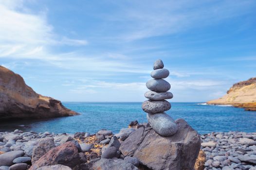 Pile of pebbles in the balance on the seacoast