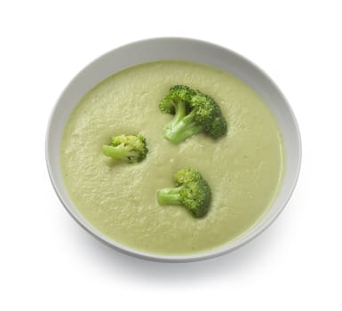 White bowl with cream soup and broccoli