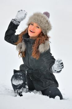 Young Beautiful Woman play in winter time