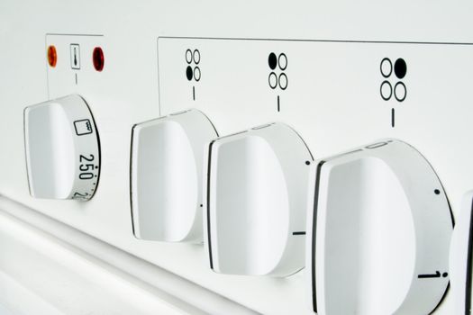 Closeup of a modern stove in light white color.