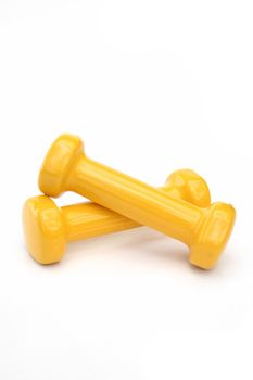 Two yellow dumbbells. All isolated on white background.