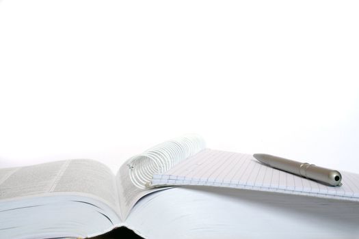 Schoolbook pen and paper to study. All isolated on white background.