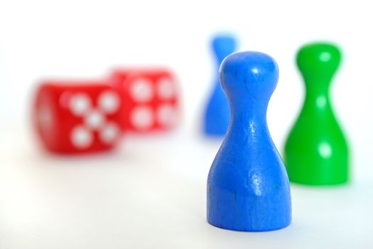 Red dices and green figures. All isolated on white background.