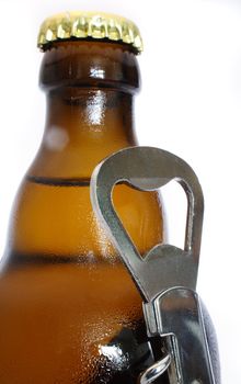 An ice cold beer and a bottle opener. All isolated on white background.