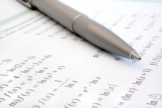 Some difficult formulas beside a silver biro.
** Note: Shallow depth of field.