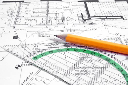 A construction plan and typical utensils of a draftsman.