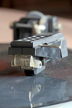 Close-up view of a record player spinning an lp vinyl record with its reflection (selective focus)