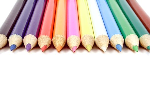 A line of colorful crayons. All isolated on white background.