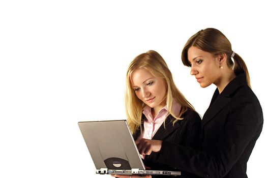 Two businesswomen reviewing something at their notebook computer. All isolated on white background.