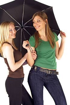 Two girlfriends sheltering under an umbrella. All isolated on white background.