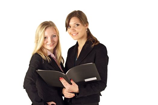 Two young business women reviewing documents. All isolated on white background.