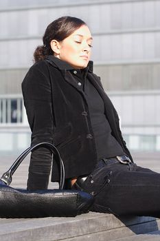 A young attractive woman sitting in the sun.