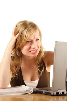 A stressed student in front of her notebook computer. All isolated on white background.