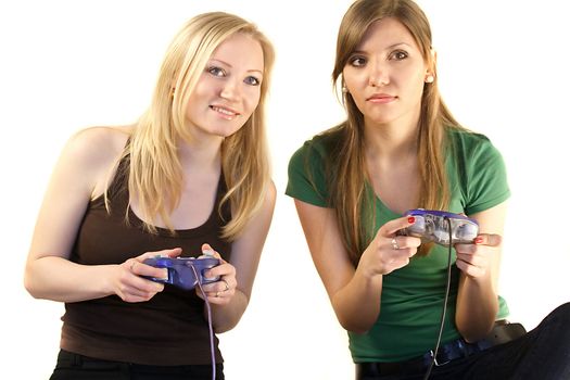 Two young girls playing video games.